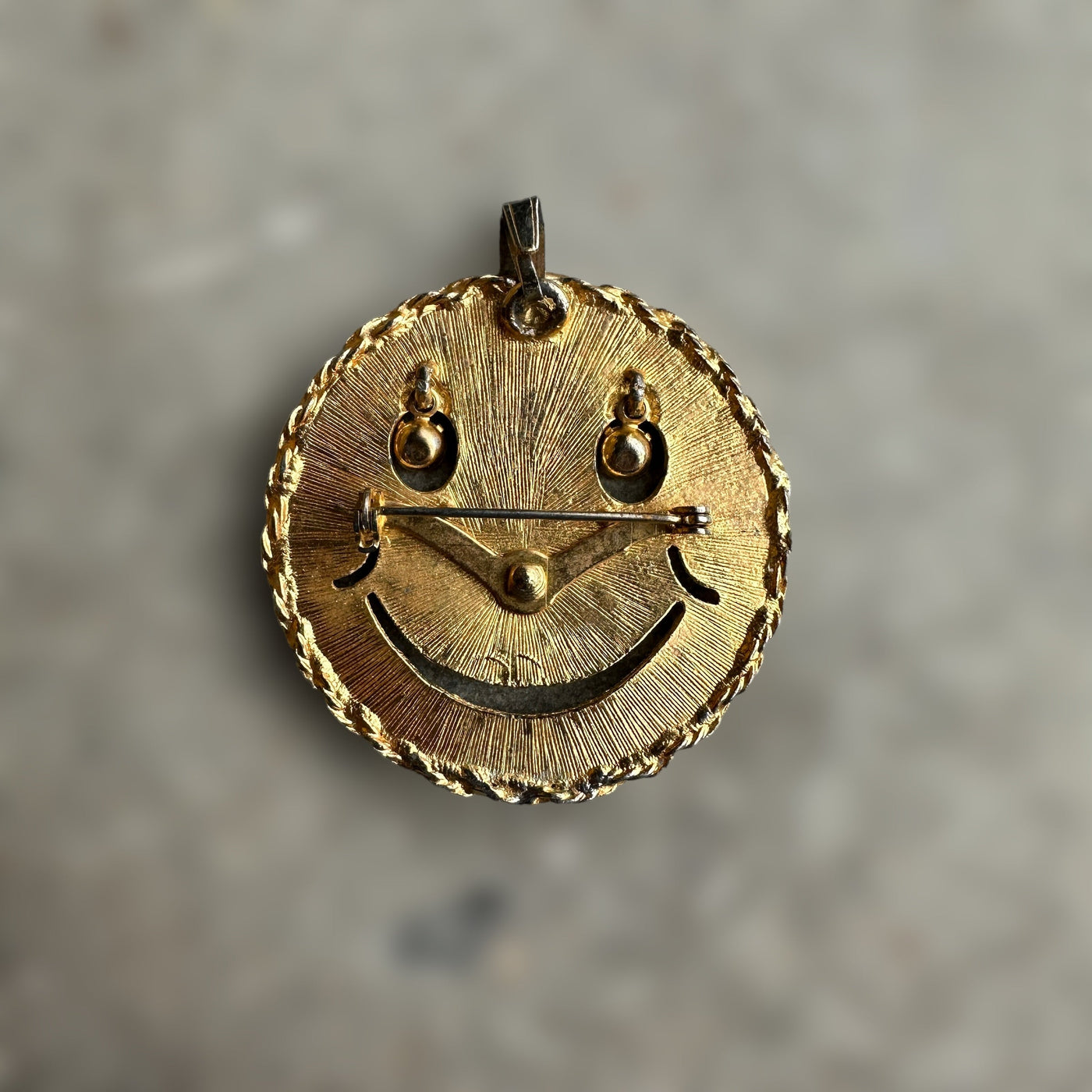 vintage smiley face brooch and pendant with articulated rhinestone eyes