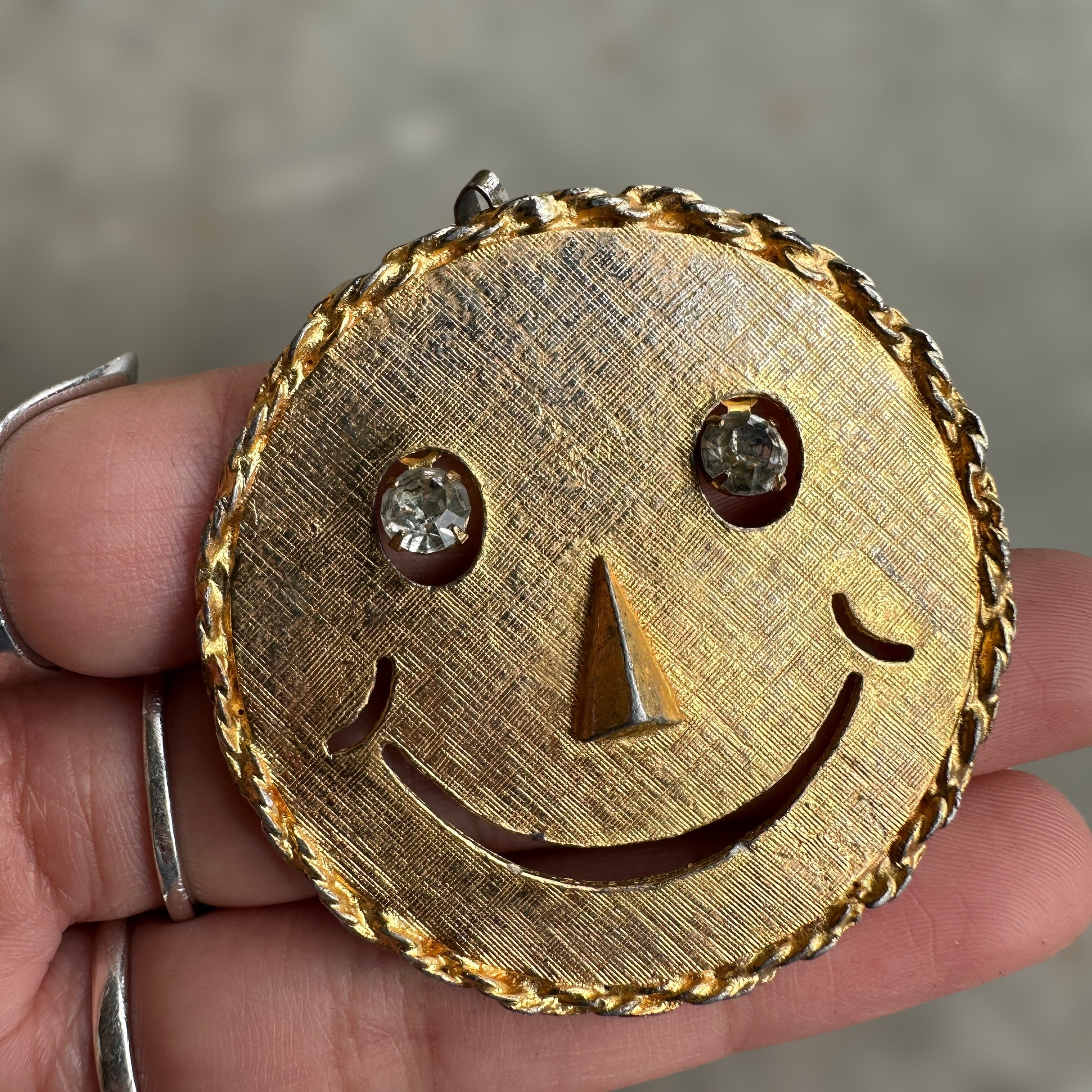 vintage smiley face brooch and pendant with articulated rhinestone eyes